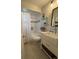 Bright bathroom featuring a tub with white shower curtain and updated sink at 10775 Glen Ellen Dr, Tampa, FL 33624