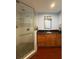 Bathroom featuring a walk-in shower with white subway tiles and a stone floor, complemented by an updated vanity at 10775 Glen Ellen Dr, Tampa, FL 33624