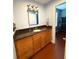 Bathroom vanity featuring wooden cabinets and updated countertops, complemented by modern fixtures and ample storage space at 10775 Glen Ellen Dr, Tampa, FL 33624