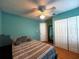 This bedroom features calming colors, a ceiling fan, a closet and a door at 10775 Glen Ellen Dr, Tampa, FL 33624