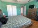 Large bedroom with wood floors, a dresser with TV, and closet in the background at 10775 Glen Ellen Dr, Tampa, FL 33624