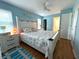 Bedroom with a floral bedspread, light blue walls, and a ceiling fan at 10775 Glen Ellen Dr, Tampa, FL 33624