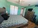 Spacious bedroom with a wooden bed frame, ceiling fan, and dresser with TV at 10775 Glen Ellen Dr, Tampa, FL 33624