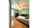 This bedroom features calming colors, a ceiling fan, and a bright window at 10775 Glen Ellen Dr, Tampa, FL 33624