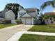 Two-story house with a one car garage, and a well maintained lawn on a sunny day at 10775 Glen Ellen Dr, Tampa, FL 33624