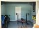 Garage featuring a workout bench, bikes, and ample storage space, perfect for fitness enthusiasts and organized living at 10775 Glen Ellen Dr, Tampa, FL 33624