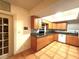 Functional kitchen with tile floors, ample counter space, oak cabinets, and modern appliances at 10775 Glen Ellen Dr, Tampa, FL 33624