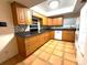 Spacious kitchen featuring granite countertops, oak cabinets, and tile flooring at 10775 Glen Ellen Dr, Tampa, FL 33624