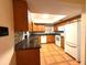 Well-lit kitchen with granite countertops, oak cabinets, and tiled floor at 10775 Glen Ellen Dr, Tampa, FL 33624
