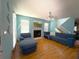 Inviting living room with hardwood floors, fireplace, and comfortable blue seating at 10775 Glen Ellen Dr, Tampa, FL 33624