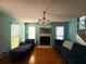 Inviting living room with a cozy fireplace, plush seating, and ample natural light from large windows at 10775 Glen Ellen Dr, Tampa, FL 33624