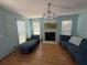Comfortable living room featuring a fireplace, plush seating, and abundant natural light at 10775 Glen Ellen Dr, Tampa, FL 33624