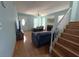 Bright living area featuring hardwood floors, fireplace, and staircase with white railing at 10775 Glen Ellen Dr, Tampa, FL 33624
