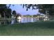 A pond and grassy area reflect the evening sky at 10775 Glen Ellen Dr, Tampa, FL 33624