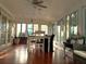 This sunroom features a large table surrounded by light-filled windows at 10775 Glen Ellen Dr, Tampa, FL 33624