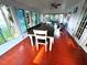 This sunroom features a large table surrounded by light-filled windows at 10775 Glen Ellen Dr, Tampa, FL 33624