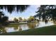 Scenic waterfront view featuring calm waters reflecting the surrounding lush greenery and picturesque homes in a serene setting at 10775 Glen Ellen Dr, Tampa, FL 33624