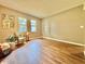 Bright bedroom featuring hardwood floors, two windows, and neutral wall colors at 10800 Us Highway 19 N # 127, Pinellas Park, FL 33782