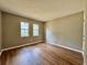 Empty bedroom featuring wood floors, two windows, and neutral wall colors at 10800 Us Highway 19 N # 127, Pinellas Park, FL 33782