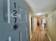Inviting home entrance featuring wood-look flooring and neutral paint at 10800 Us Highway 19 N # 127, Pinellas Park, FL 33782