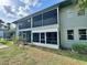 Exterior view of property featuring a screened balcony and a screened patio at 10800 Us Highway 19 N # 127, Pinellas Park, FL 33782