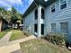 Exterior of a two-story building with arched balconies, a blue exterior, and landscaped surroundings at 10800 Us Highway 19 N # 127, Pinellas Park, FL 33782