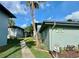 Well-maintained building exterior with lush landscaping and mature palm trees at 10800 Us Highway 19 N # 127, Pinellas Park, FL 33782