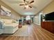 Cozy living room with a comfortable white sofa, wooden floors, and a ceiling fan that adds comfort at 10800 Us Highway 19 N # 127, Pinellas Park, FL 33782