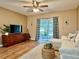 Cozy living area with wood flooring, sliding glass doors to patio, and stylish decor at 10800 Us Highway 19 N # 127, Pinellas Park, FL 33782