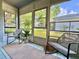 Enclosed sunroom featuring tile flooring and views of the surrounding greenery at 10800 Us Highway 19 N # 127, Pinellas Park, FL 33782