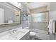 Neutral bathroom featuring a vanity with a stylish mirror and a shower with glass doors at 11029 Lynn Lake Cir, Tampa, FL 33625