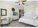 Bedroom featuring a desk and a TV, along with a stylish mirror and storage at 11029 Lynn Lake Cir, Tampa, FL 33625