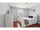 Cozy bedroom with hardwood floors, a window view, and a dresser at 11029 Lynn Lake Cir, Tampa, FL 33625