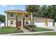 Charming two-story home with well-manicured lawn, mature landscaping, and a red front door at 11029 Lynn Lake Cir, Tampa, FL 33625