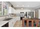 Bright kitchen features white cabinets, stainless steel appliances, and granite countertops with a decorative kitchen island at 11029 Lynn Lake Cir, Tampa, FL 33625