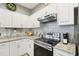 Well-equipped kitchen featuring granite countertops, stainless steel appliances, and ample cabinet space for storage at 11029 Lynn Lake Cir, Tampa, FL 33625