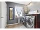 This laundry room is complete with modern washer and dryer and stylish decor at 11029 Lynn Lake Cir, Tampa, FL 33625
