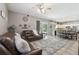 Cozy living room with tile floors, recessed lighting, and an open layout leading into the kitchen and dining area at 11029 Lynn Lake Cir, Tampa, FL 33625