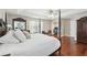 Large main bedroom featuring a four-poster bed and a view of the office at 11029 Lynn Lake Cir, Tampa, FL 33625
