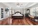 Spacious main bedroom with dark wood furniture, hardwood floors, and ample natural light at 11029 Lynn Lake Cir, Tampa, FL 33625