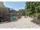 Spacious backyard patio with statues, fountains, screened-in pool, string lights, and a seating area for relaxation at 11029 Lynn Lake Cir, Tampa, FL 33625