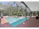 Relax by the screened pool with water feature and lush landscaping, perfect for outdoor enjoyment at 11029 Lynn Lake Cir, Tampa, FL 33625