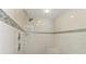 Walk-in shower featuring sleek fixtures and tile surround, with a built in seat at 11029 Lynn Lake Cir, Tampa, FL 33625