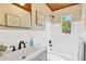 Clean and modern bathroom with white tile, black fixtures, and natural lighting at 1128 S 70Th St, Tampa, FL 33619
