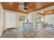 Dining room with hardwood ceiling and hardwood floors, open to the living room and kitchen at 1128 S 70Th St, Tampa, FL 33619