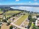 An aerial view showing the surrounding landscape, nearby lake, and home circled in white at 11921 Fort King Hwy, Thonotosassa, FL 33592
