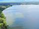 Aerial photograph reveals the property's expansive waterfront setting on a large lake at 11921 Fort King Hwy, Thonotosassa, FL 33592