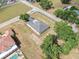 Aerial view of the home showcasing the well-manicured lot, trees, and proximity to the road at 11921 Fort King Hwy, Thonotosassa, FL 33592