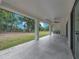 Expansive back porch perfect for entertaining, featuring an outdoor kitchen and green space at 11921 Fort King Hwy, Thonotosassa, FL 33592