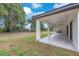 Covered back porch with ample space and outdoor kitchen, overlooking the lush yard at 11921 Fort King Hwy, Thonotosassa, FL 33592